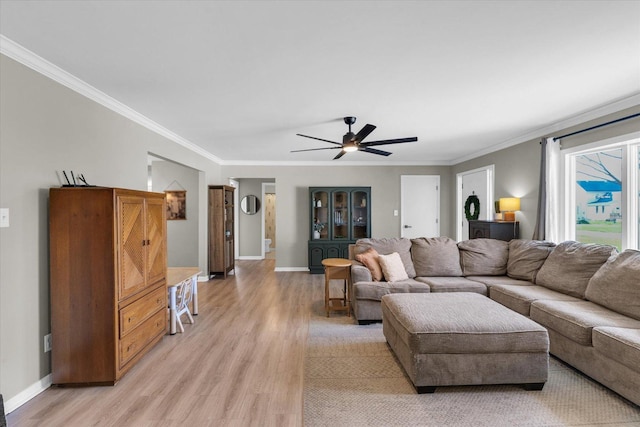 415 E 14th St, Gibson City, IL 60936 - living room featuring light wood-style flooring, baseboards, a ceiling fan, and crown molding