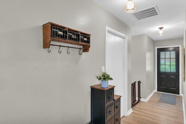 415 E 14th St, Gibson City, IL 60936 - foyer featuring light wood-type flooring, baseboards, and visible vents