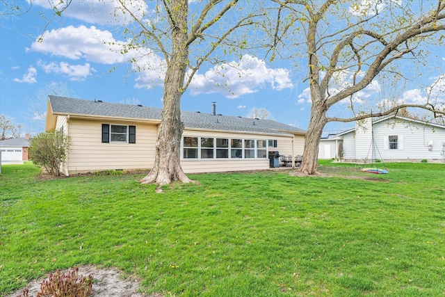 415 E 14th St, Gibson City, IL 60936 - rear view of property featuring a lawn and a trampoline