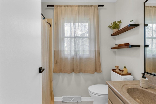 415 E 14th St, Gibson City, IL 60936 - bathroom featuring toilet, vanity, and visible vents