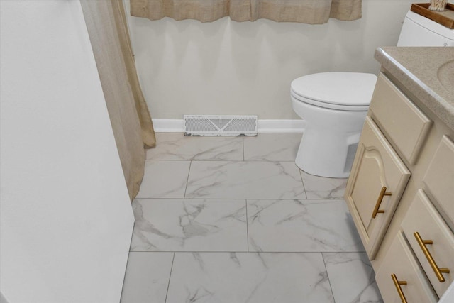 415 E 14th St, Gibson City, IL 60936 - full bath with visible vents, marble finish floor, vanity, and toilet