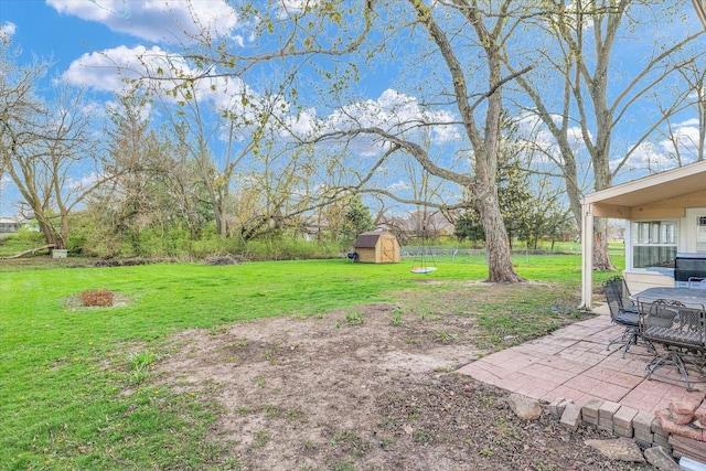 415 E 14th St, Gibson City, IL 60936 - view of yard with fence, a patio, an outbuilding, and a shed