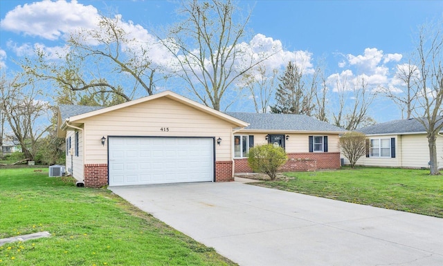 415 E 14th St, Gibson City, IL 60936 - ranch-style home with a garage, driveway, a front lawn, and brick siding