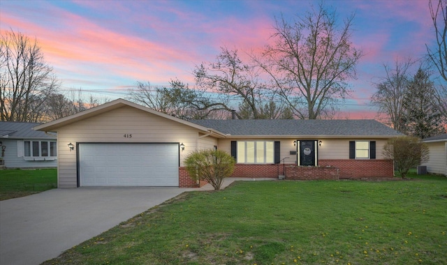 415 E 14th St, Gibson City, IL 60936 - ranch-style house featuring brick siding, a front lawn, driveway, and a garage