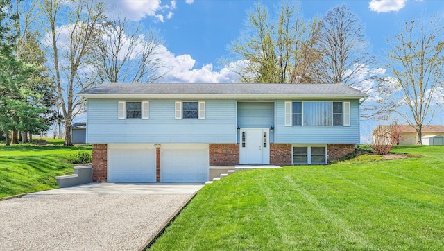 2 Woodland Dr, White Heath, IL 61884 - split foyer home featuring an attached garage, a front lawn, driveway, and brick siding