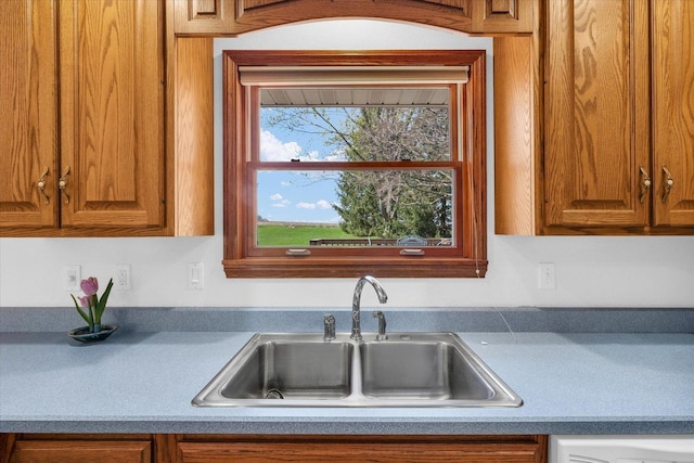 2 Woodland Dr, White Heath, IL 61884 - kitchen featuring a sink and brown cabinetry