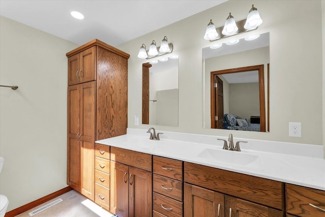 2 Woodland Dr, White Heath, IL 61884 - full bathroom with double vanity, toilet, ensuite bathroom, and baseboards