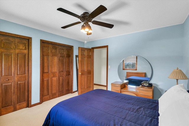 2 Woodland Dr, White Heath, IL 61884 - carpeted bedroom featuring two closets, a ceiling fan, and baseboards