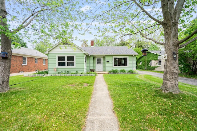 918 Dawes Ave, Joliet, IL 60435 - view of front facade featuring a chimney and a front yard