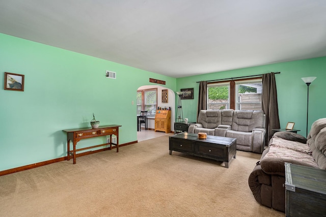 918 Dawes Ave, Joliet, IL 60435 - living room with arched walkways, light carpet, and baseboards