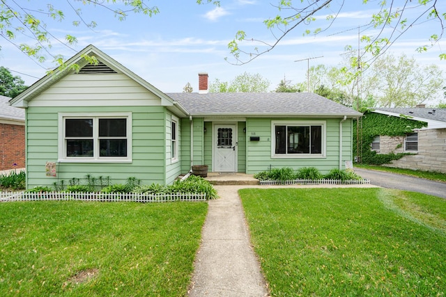 918 Dawes Ave, Joliet, IL 60435 - view of front of property with a chimney, a front lawn, and a shingled roof