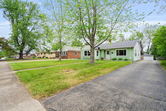 918 Dawes Ave, Joliet, IL 60435 - ranch-style house with an outdoor structure, a front yard, a chimney, a shingled roof, and a detached garage