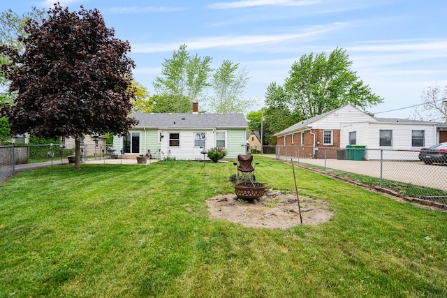 918 Dawes Ave, Joliet, IL 60435 - back of house featuring a fire pit, a patio, and a chimney