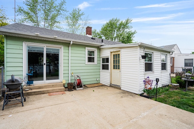 918 Dawes Ave, Joliet, IL 60435 - rear view of house with entry steps, a patio area, a chimney, and roof with shingles
