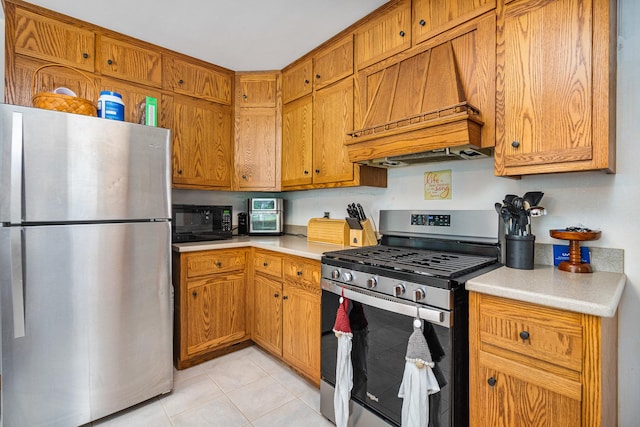 918 Dawes Ave, Joliet, IL 60435 - kitchen with stainless steel appliances, custom exhaust hood, light countertops, light tile patterned floors, and brown cabinetry