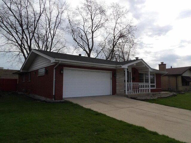 16315 Kenwood Ave, South Holland, IL 60473 - view of side of home featuring a porch, a garage, a lawn, driveway, and brick siding
