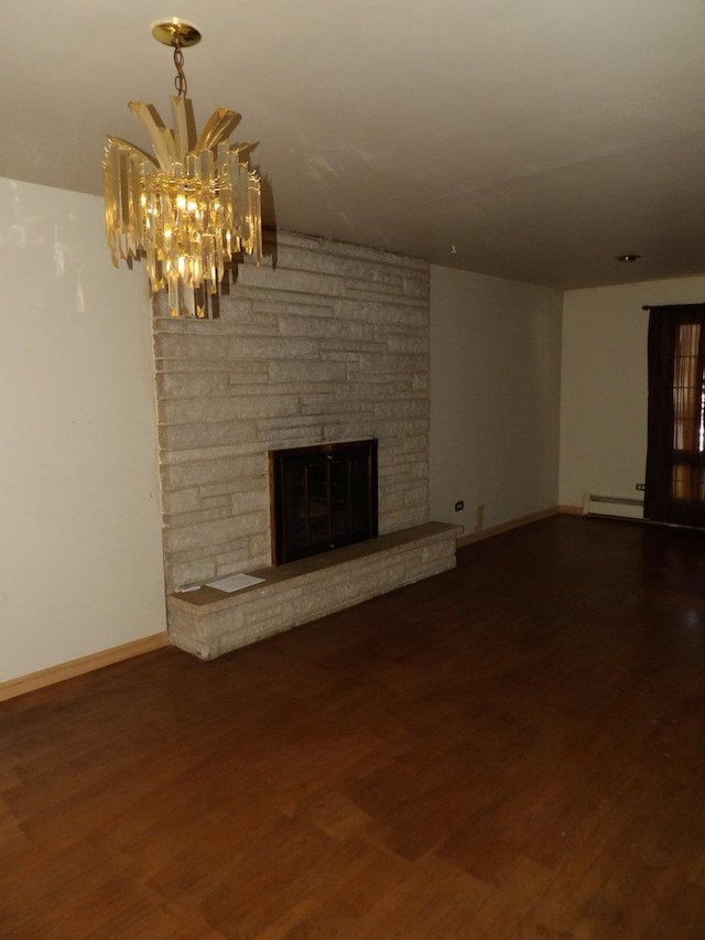16315 Kenwood Ave, South Holland, IL 60473 - unfurnished living room featuring a chandelier, a stone fireplace, baseboards, baseboard heating, and wood finished floors