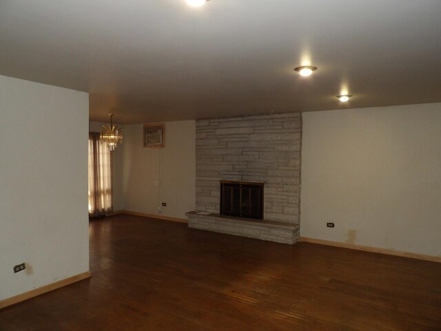 16315 Kenwood Ave, South Holland, IL 60473 - unfurnished living room featuring baseboards, wood finished floors, a notable chandelier, and a fireplace