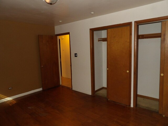 16315 Kenwood Ave, South Holland, IL 60473 - unfurnished bedroom featuring wood finished floors, two closets, and baseboards