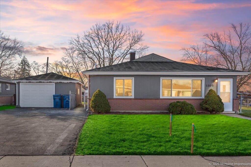 1305 Woodview Ave, Calumet City, IL 60409 - bungalow-style home with aphalt driveway, a front lawn, brick siding, a chimney, and a garage