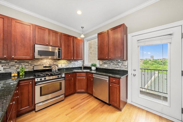 3443 N Lincoln Ave Unit 4A, Chicago, IL 60657 - kitchen featuring appliances with stainless steel finishes, light wood-style floors, backsplash, a sink, and crown molding