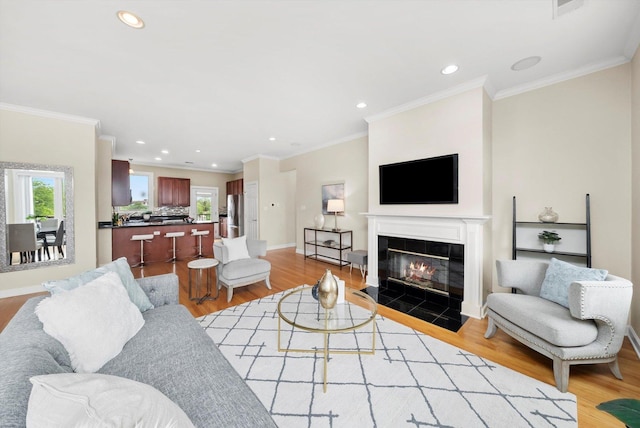 3443 N Lincoln Ave Unit 4A, Chicago, IL 60657 - living room featuring light wood-style flooring, recessed lighting, a tile fireplace, crown molding, and baseboards