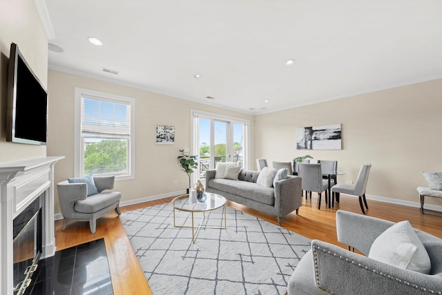 3443 N Lincoln Ave Unit 4A, Chicago, IL 60657 - living room with crown molding, baseboards, a fireplace with flush hearth, wood finished floors, and recessed lighting