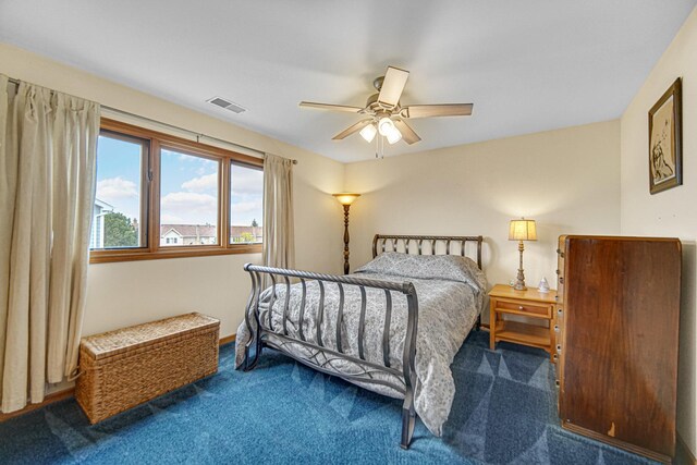 carpeted bedroom featuring visible vents and ceiling fan
