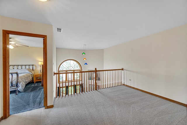 hall featuring baseboards and carpet