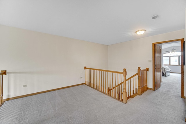 unfurnished room with carpet and baseboards