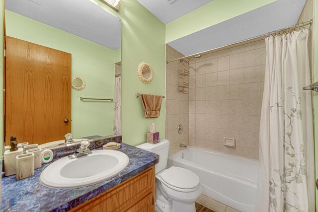 bathroom with shower / tub combo, toilet, and vanity