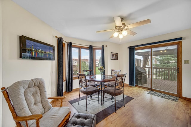 dining room with light wood-style flooring, baseboards, a wealth of natural light, and ceiling fan
