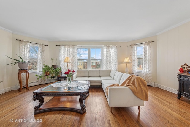 living room featuring a wealth of natural light, ornamental molding, and wood finished floors