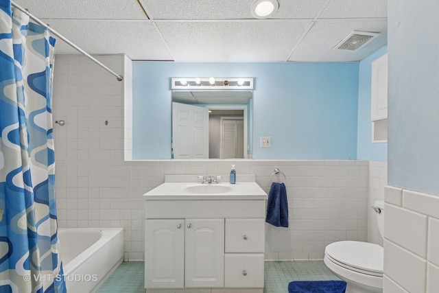 full bathroom with visible vents, tile walls, vanity, and tile patterned floors
