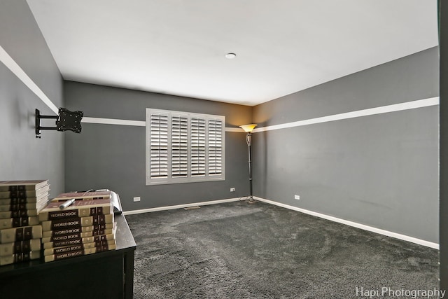 unfurnished bedroom featuring baseboards and carpet flooring