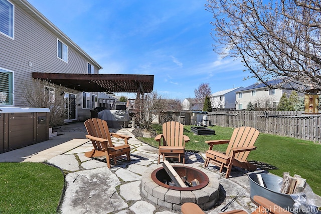 view of patio / terrace featuring a residential view, area for grilling, a fenced backyard, an outdoor fire pit, and a jacuzzi