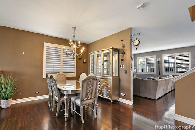dining room with baseboards, a chandelier, and hardwood / wood-style flooring