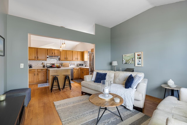 living room with lofted ceiling and light wood finished floors