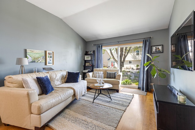 living area with lofted ceiling and wood finished floors