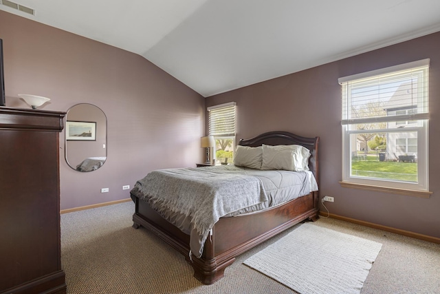 carpeted bedroom featuring lofted ceiling and baseboards