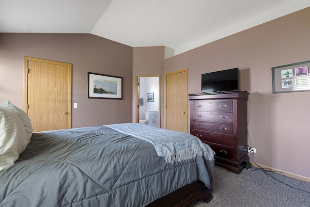 bedroom featuring vaulted ceiling, carpet flooring, ensuite bathroom, and baseboards
