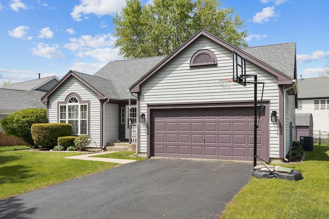 ranch-style house with driveway, roof with shingles, an attached garage, and central air condition unit