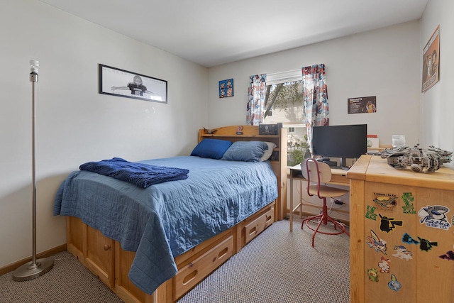 bedroom featuring carpet flooring, an office area, and baseboards
