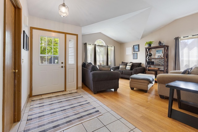 entrance foyer with light tile patterned floors and lofted ceiling