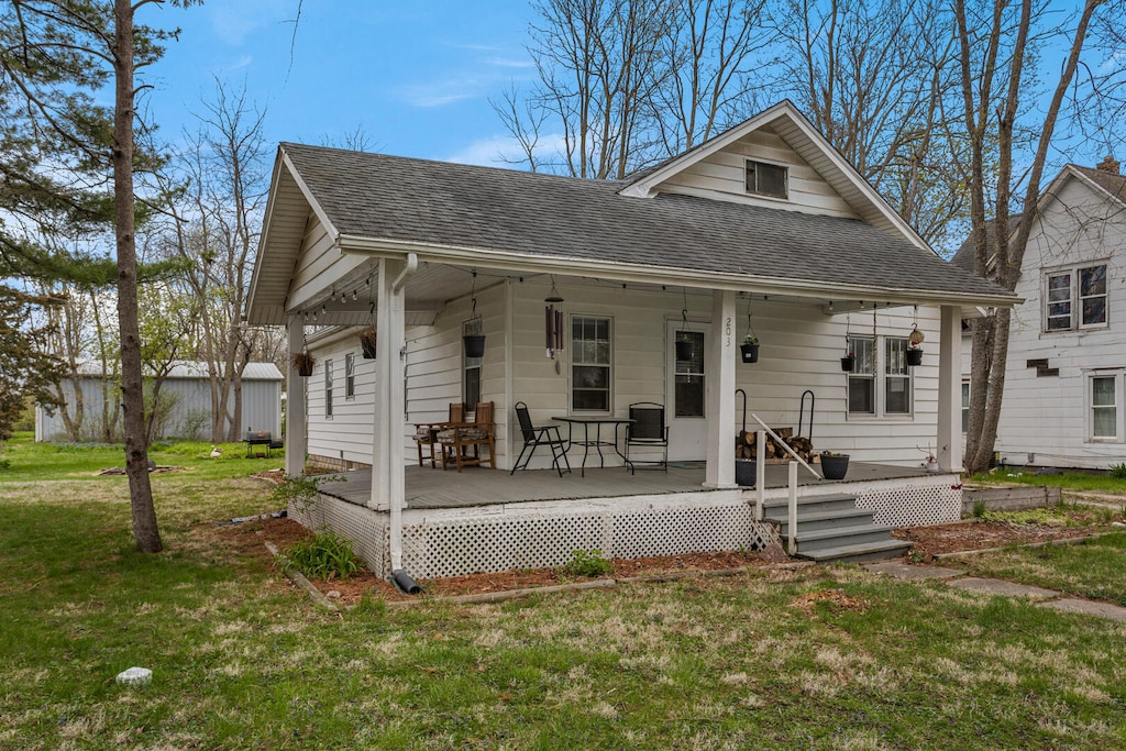 203 S Market St, Bondville, IL 61815 - bungalow with a front lawn, a porch, and a shingled roof