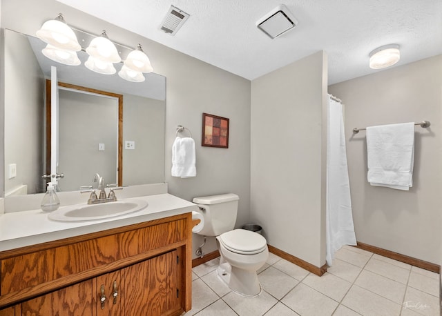 bathroom featuring toilet, visible vents, and baseboards