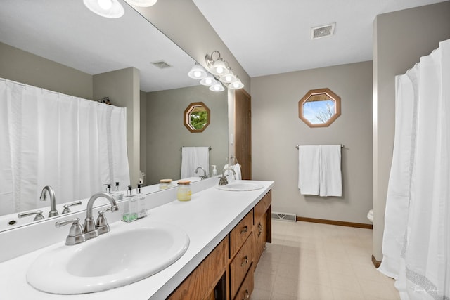 full bath with visible vents, a sink, and toilet
