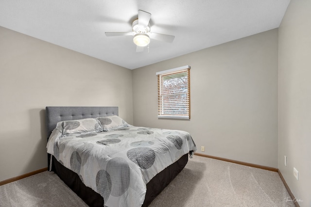 bedroom with carpet floors, a ceiling fan, and baseboards