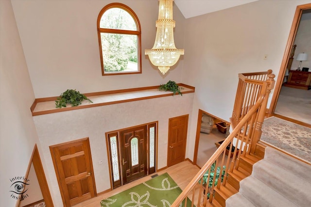 entrance foyer with a chandelier and a towering ceiling