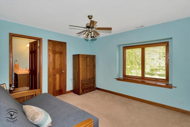 bedroom with light colored carpet, baseboards, connected bathroom, and ceiling fan